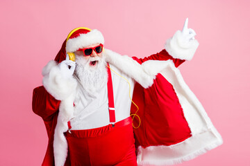 Photo of crazy funky santa claus enjoy listen x-mas christmas newyear fairy radio song headphones...