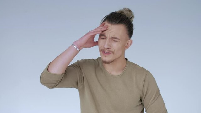 Facepalm. The young man is perplexed. Spanish shame