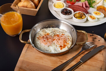 Traditional Turkish breakfast. Village Breakfast, copper egg pan, sausage, butter, olive, cheese, honey and bred