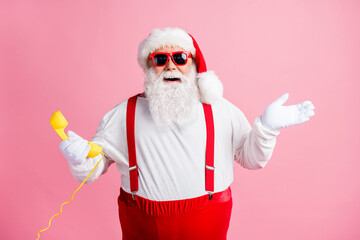 Fototapeta na wymiar Portrait of his he nice attractive cheerful cheery glad Santa father talking on yellow phone contact center communication ho-ho holly jolly isolated over pink pastel color background