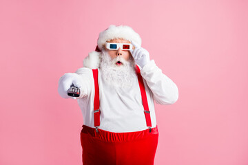 Fototapeta na wymiar Portrait of his he nice attractive amazed stunned guy Santa father watching series show switching channel pout lips omg wow touching 3d specs isolated pink pastel color background