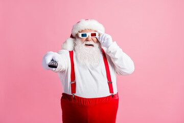 Portrait of his he nice attractive cheerful cheery guy Santa watching series show switching channel...