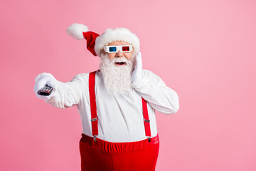 Fototapeta na wymiar Portrait of his he nice attractive cheerful cheery glad amazed fat Santa watching film video switching channel enjoying pastime amusement air blow wind isolated pink pastel color background