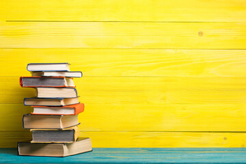Books on wooden desk table and abstract background. Education background. Copy Space. Back to...