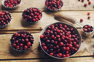 Ripe organic cranberry on rustic wooden table