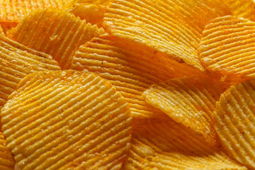 macro of beautiful corrugated yellow chips under the sun's rays