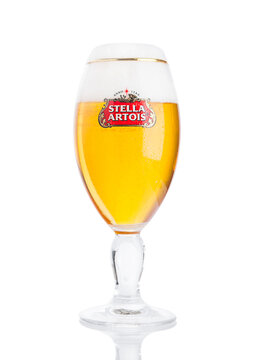 LONDON, UK -NOVEMBER 29. 2016  Cold glass of Stella Artois beer on white background, prominent brand of Anheuser-Busch InBev, is a pilsner brewed in Leuven, Belgium, since 1926