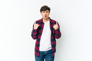 Fototapeta premium Young cool man pointing upside with opened mouth.