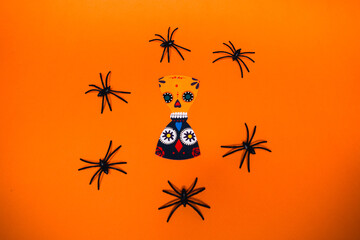 flatlay false paper photo booth props for Dia de los Muertos on orange background copyspace for Day of the dead and Halloween greeting card