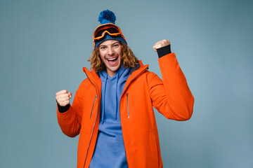 Handsome excited sportsman making winner gesture on camera