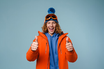Young excited sportsman winking and showing thumbs up