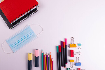 different stationary items of various colours on light surface.