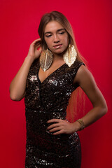 Fototapeta premium Beautiful european girl on a red background is experiencing joy and happiness