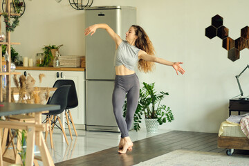 millennial girl wearing have fun moving listening to music relax in living room, happy young woman dance enjoy leisure weekend at home, stress free concept. Slow Motion video. Close up stock footage.