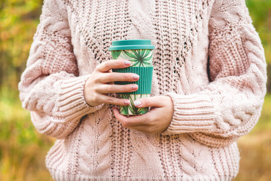 close-up of a holding recycable reusable takeaway coffee cup. Sustainable lifestyle. Eco-friendly, zero waste concept