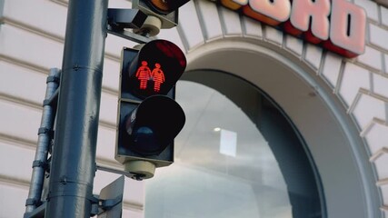 Cute view of red traffic lights, showing two female silhouettes in amsterdam. Progressive modern sign of acceptance and political correct culture.