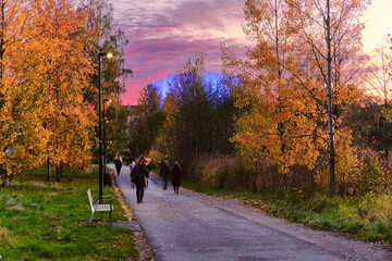 Pedestrian path in Kluuvi central district of Helsinki in Autumn fall. Beautiful sunset and blue light for Helsinki Hall on the background, Finland.