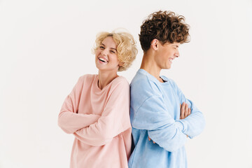 Positive loving couple posing isolated over white background