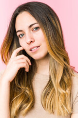 Young beautiful woman isolated on pink background