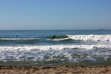 Surfing in corona times at Forte dei Marmi, Tuscany, Italy