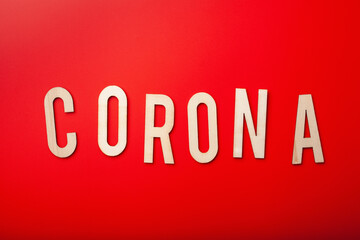 corona word text wooden letter on red background corona virus covid-19