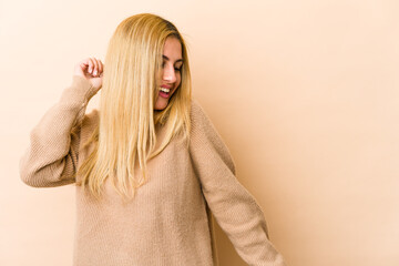 Young blonde caucasian woman dancing and having fun.