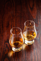 glass of whisky spirit brandy on dark brown background