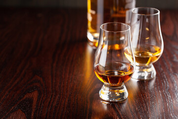 glass of whisky spirit brandy on dark brown background