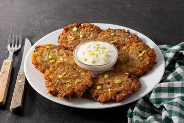 Traditional Jewish latkes or potato pancakes on black stone