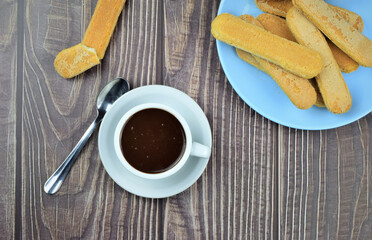 Hot liquid chocolate, in white cup and plate on the table