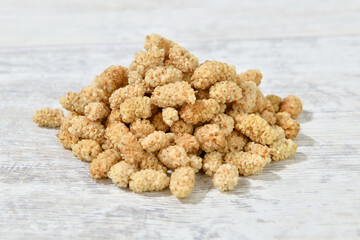 Heap of dried mulberry on table
