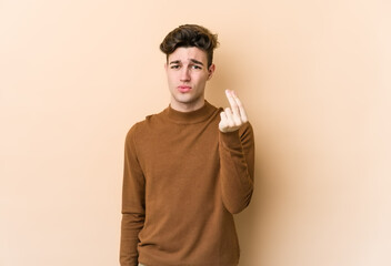 Young caucasian man isolated on beige background showing that she has no money.