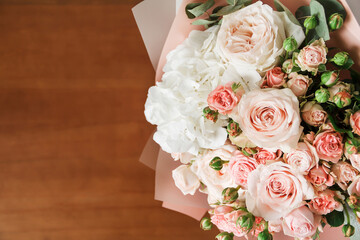 Lovely bouquet with pink roses close-up. Background with flowers with free space. Background for congratulations and place for text. Flowers for birthday. A bouquet of flowers is on the table.