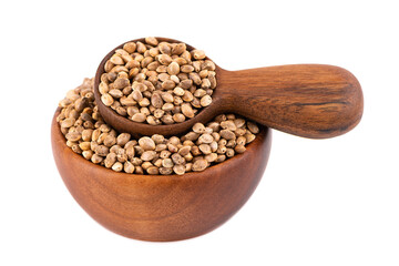 Hemp seeds isolated on white background. Dry seeds of cannabis, hemp or marijuana in wooden bowl and spoon.