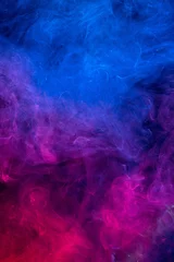Cercles muraux Fumée Conceptual image of colorful red and blue color smoke on dark black background.