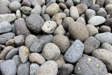 A close up view on pebbles and stones as natural decoration in the garden