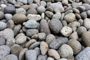 A close up view on pebbles and stones as natural decoration in the garden