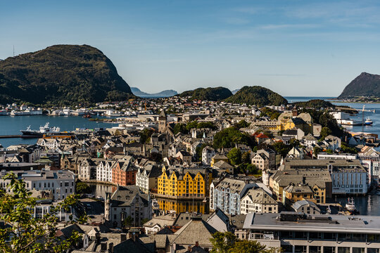 &Aring;lesund Norway View of &Aring;lesund in Norway on a sunny day with mountain ranges in the background with water around