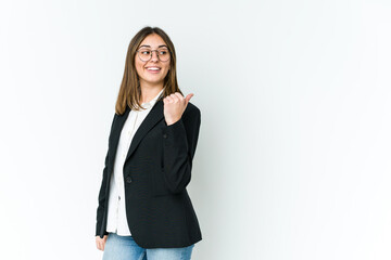Obraz premium Young caucasian business woman points with thumb finger away, laughing and carefree.