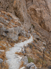 Fototapeta na wymiar Tourist on the mountain path, Thira island, Greece.