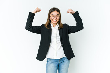 Obraz premium Young caucasian business woman showing strength gesture with arms, symbol of feminine power