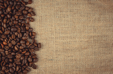 Roasted coffee beans on burlap. Background for coffee shops and store websites