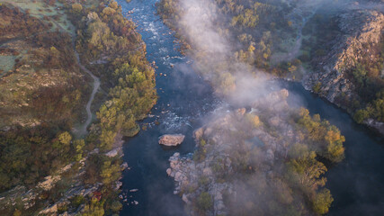 amazing aerial view of foggy morning river and colorful trees. drone shot