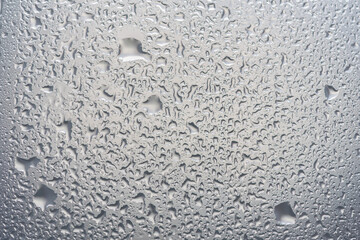 water drops on glass background texture. rain on the grey window