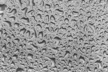 water drops on glass background texture. rain on the grey window