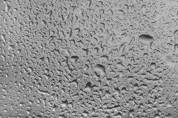 water drops on glass background texture. rain on the grey window