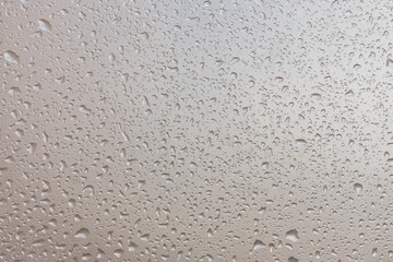 water drops on glass background texture. rain on the grey window