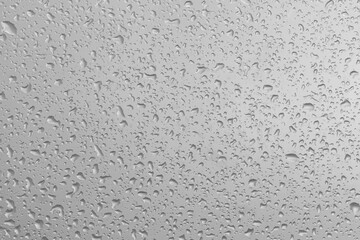 water drops on glass background texture. rain on the grey window