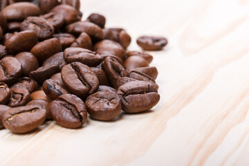Fresh roasted coffee beans on wooden table. Macro shot.