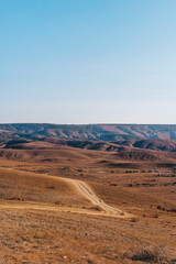 Landscape of hills at dawn with road